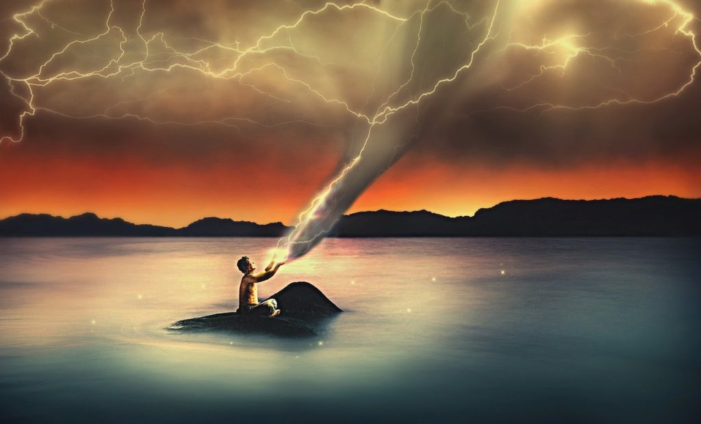 A man sitting on a rock in the middle of a lake. Lighting and storms are leaving his hands and traveling up into the sky. Lighting arcs overhead, and the far horizon is red with sunrise or sunset.